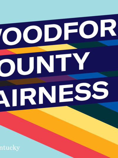 Graphic with light blue background and three slanted bars with rainbow stripes giving a 3D effect. Each bar has one line of text. Together the read, "Woodford County Fairness Meeting"