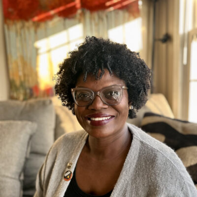 j reid wears glasses and a sweater