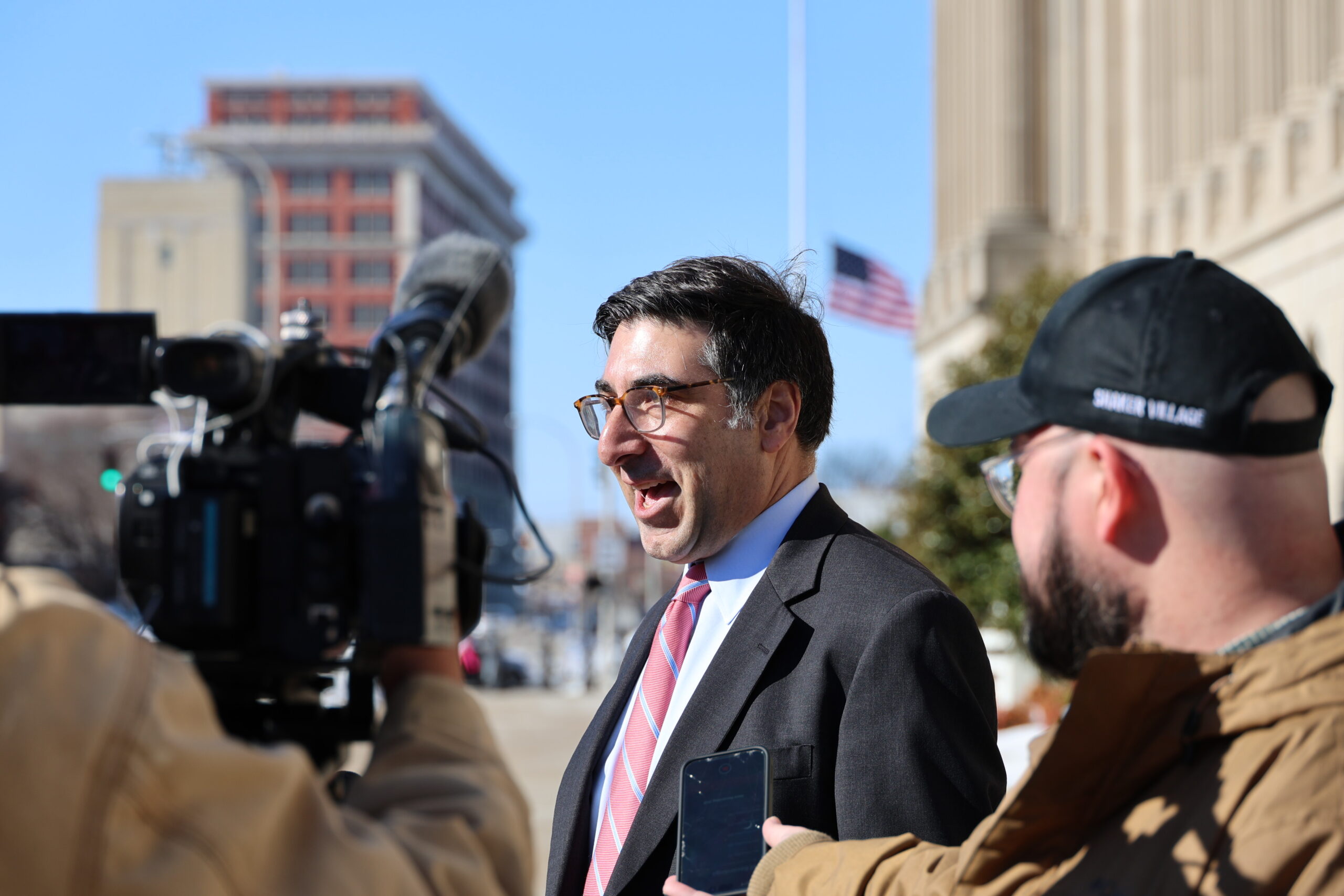 Legal Director Corey Shapiro talks with media after a court hearing.