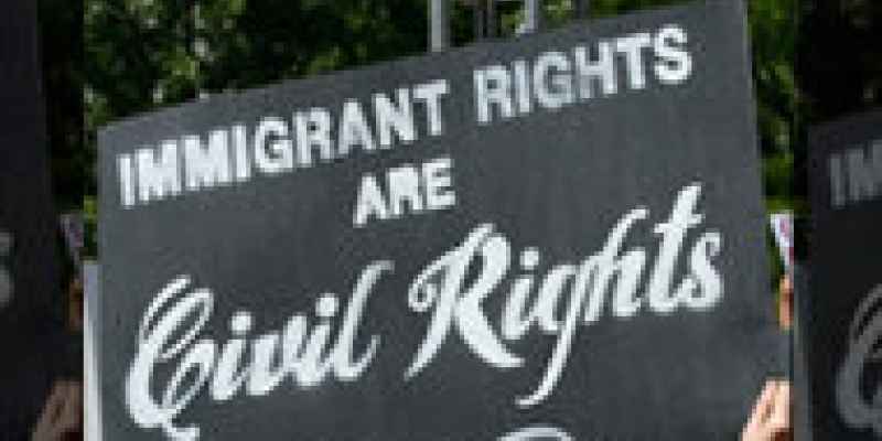 Woman holding sign that says "Immigrant Rights are Civil Rights."