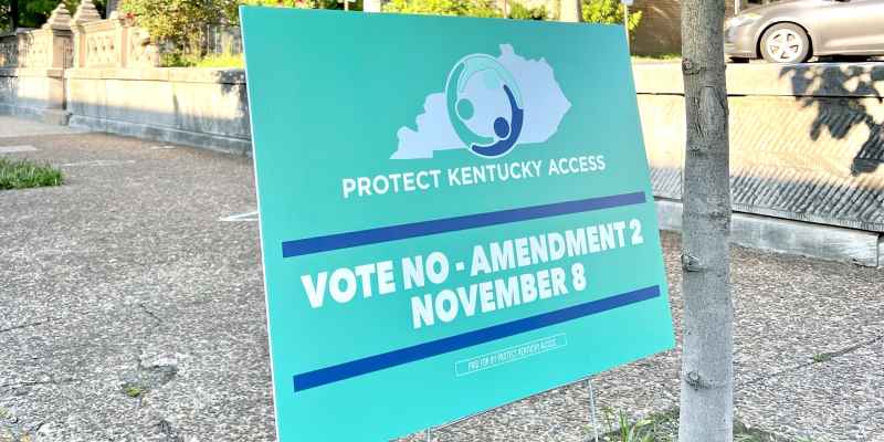 Green yard sign that reads "Protect Kentucky Access Vote NO - Amendment 2, November 8"
