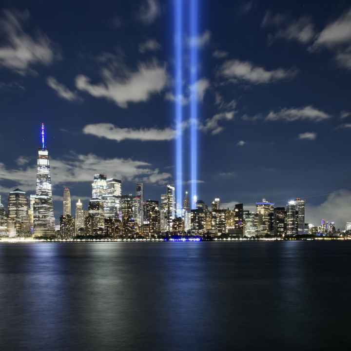 A photo of the Manhattan skyline with two lights where the World Trade Center Twin Towers used to be.